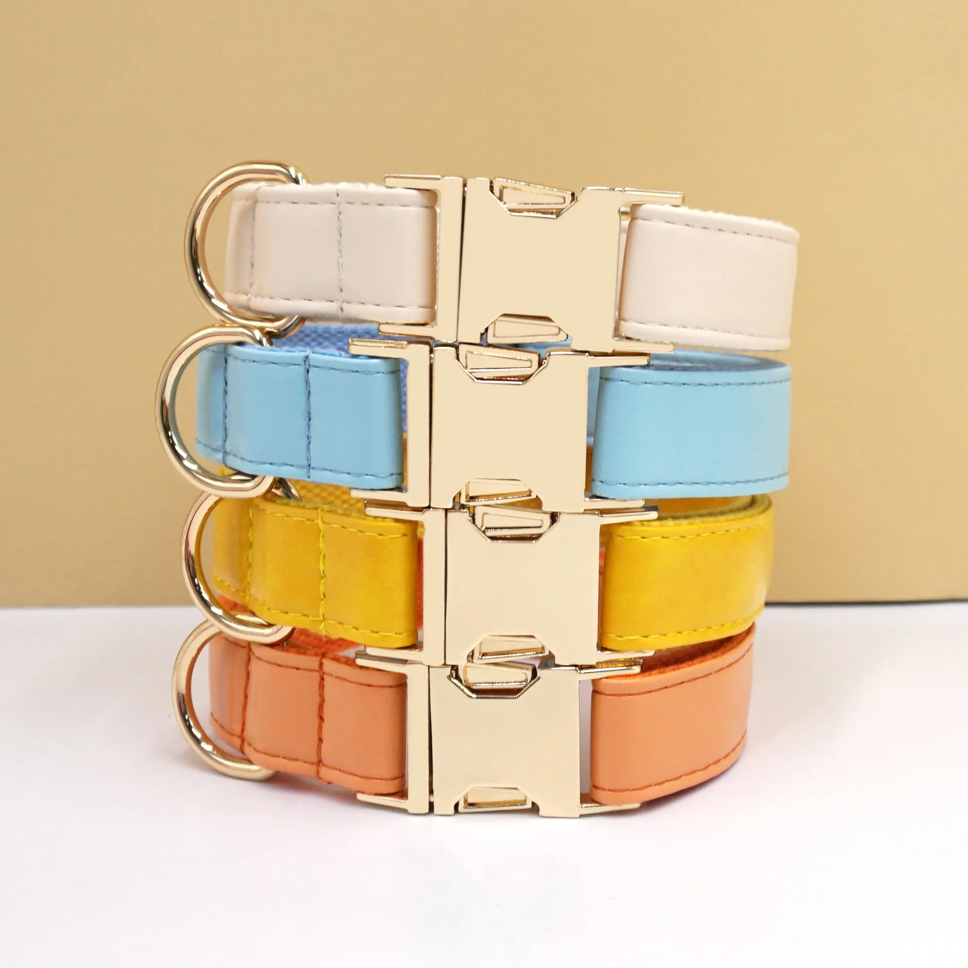 Leather dog collar with velvet texture section in colour block design, shown on a buckle.