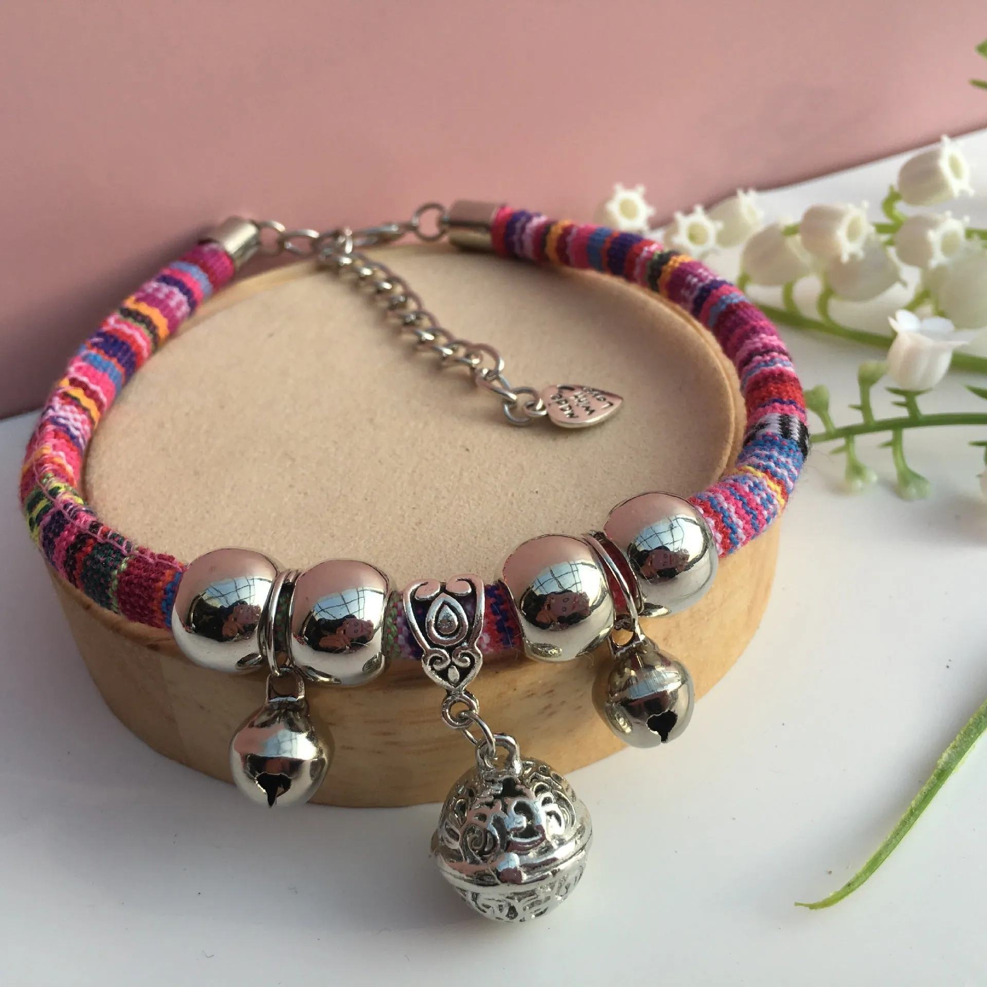 Coloured single bell pet bell attachment with a metal bracket for attaching to collar