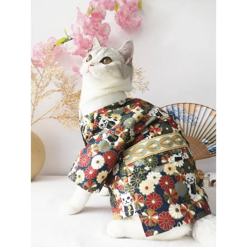 Small dog wearing a cherry blossom print kimono-style pet clothing in a standing pose