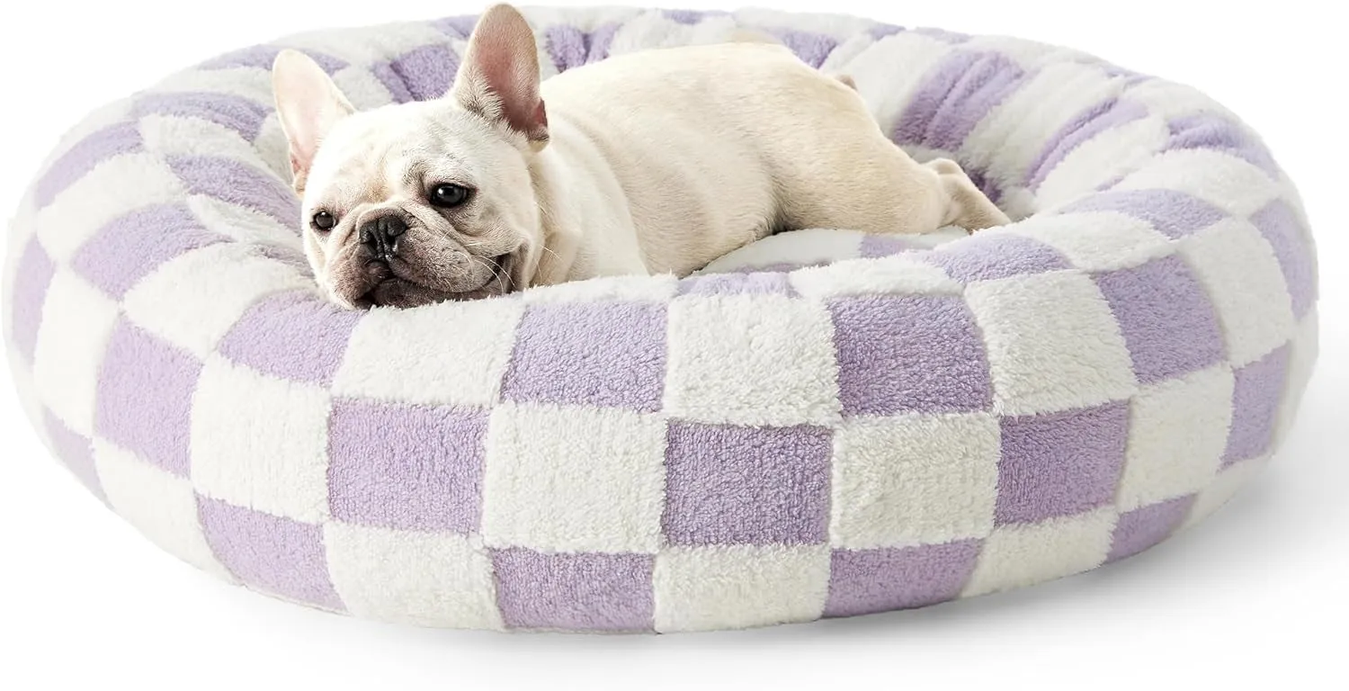 Round plaid dog bed with a raised edge on a plastic base, shown in a sea blue and white colour.