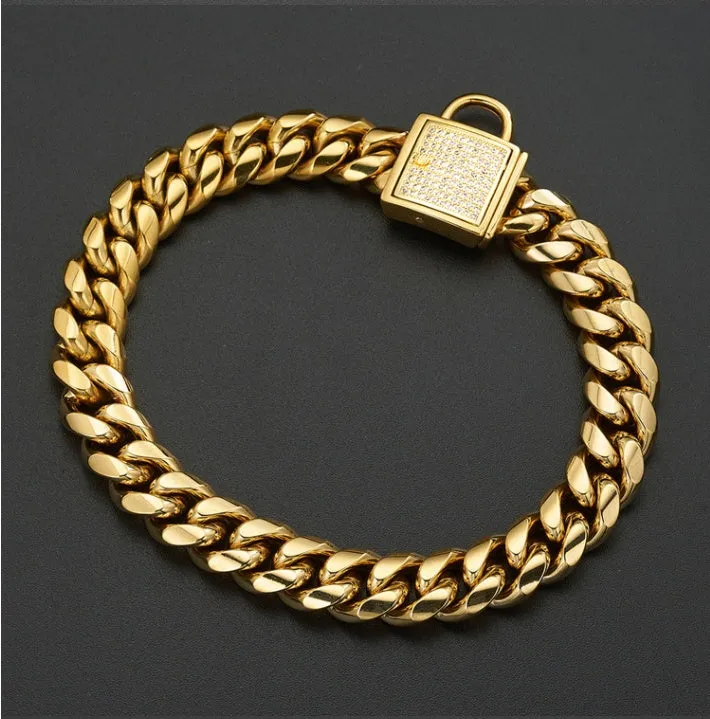 Gold titanium steel pet dog collar with encryption chain buckle lying on surface