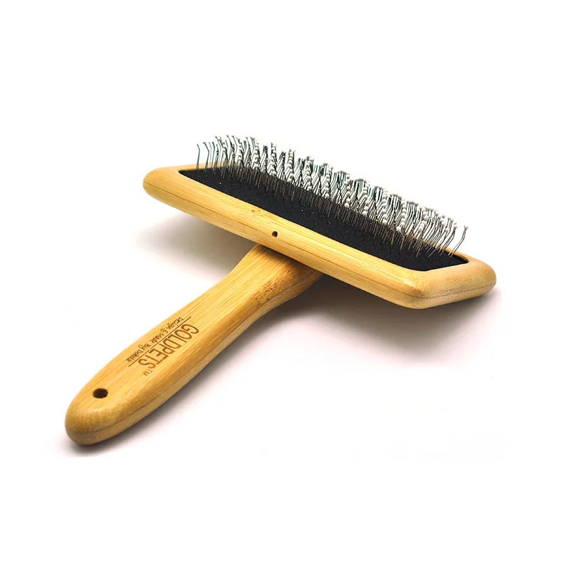 Pet grooming bamboo wood air cushion needle comb with original bamboo colour handle and steel pins on a clean background