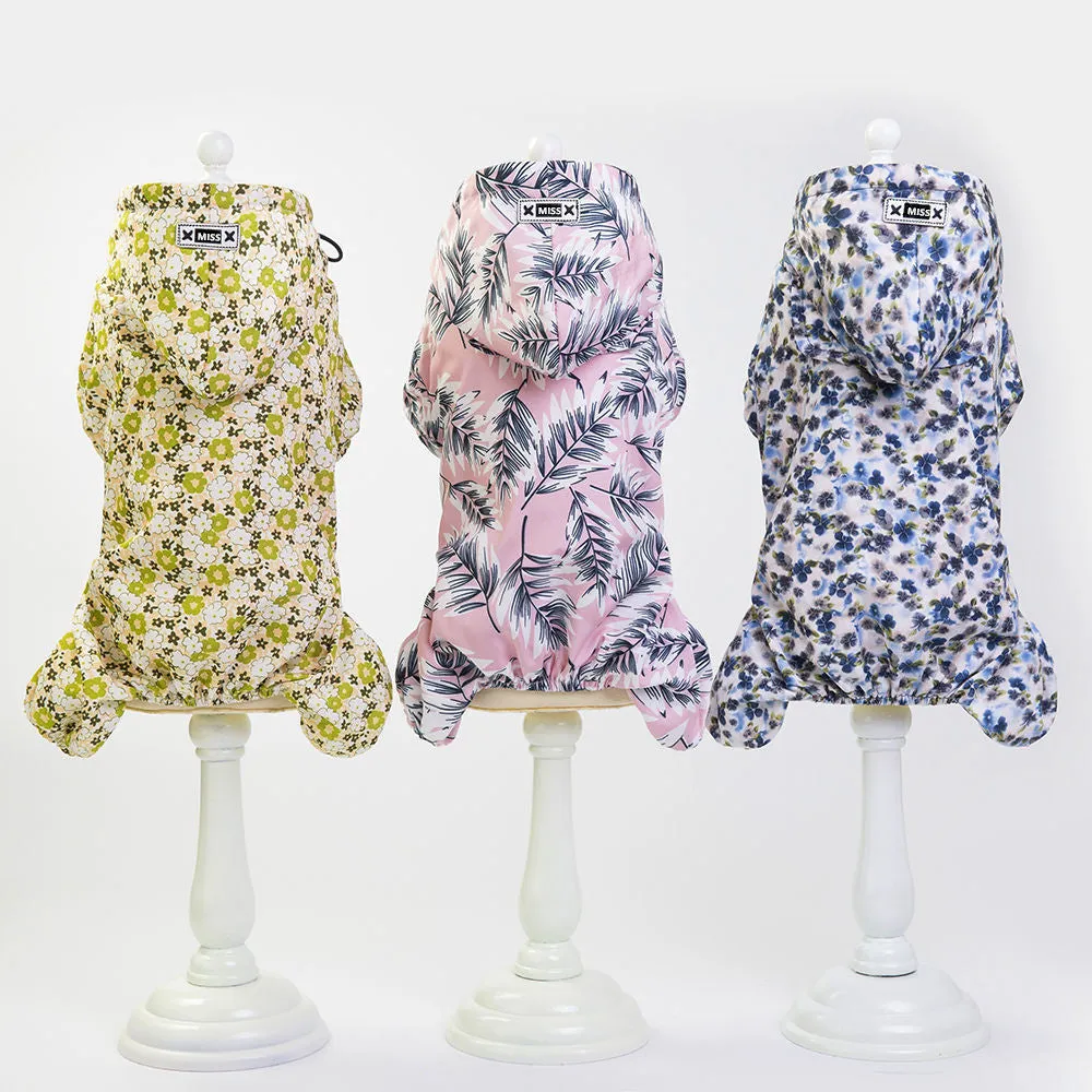 Waterproof dog raincoat in pink, four-legged jumpsuit style, on a small dog
