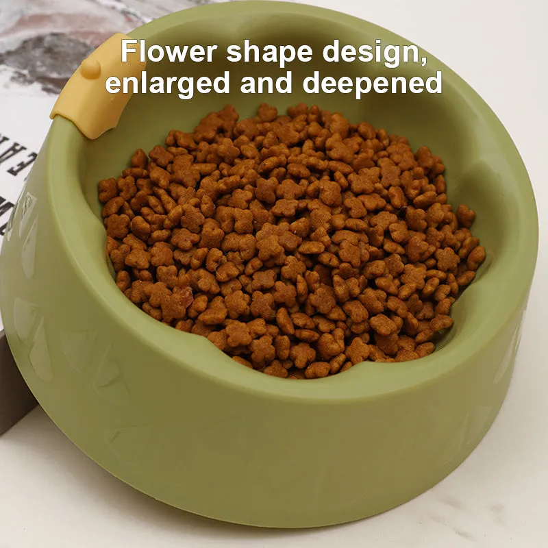 Green flower-shaped plastic double bowl for cat or small dog food and water on a plain surface.