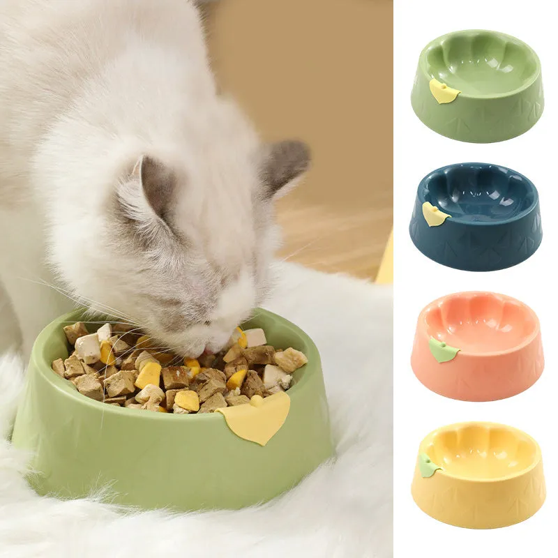 Green flower-shaped plastic double bowl for cat or small dog food and water on a plain surface.