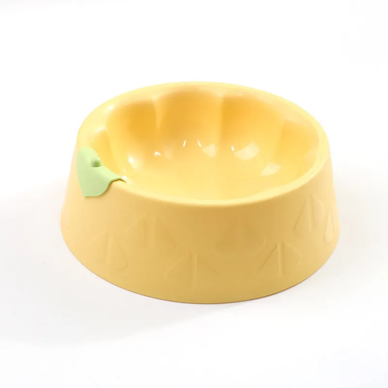 Green flower-shaped plastic double bowl for cat or small dog food and water on a plain surface.