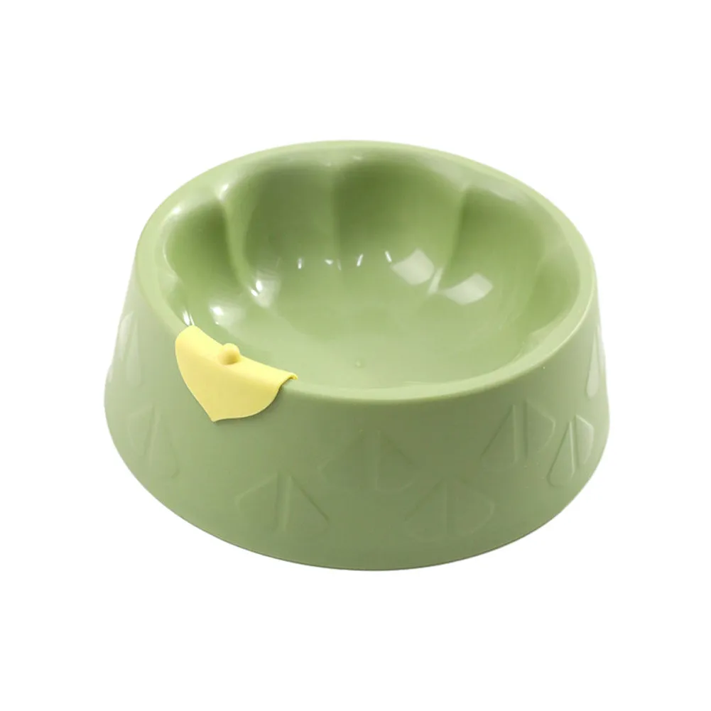 Green flower-shaped plastic double bowl for cat or small dog food and water on a plain surface.