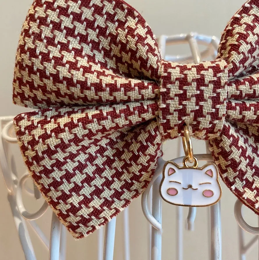 Cloth pet bow tie decoration in wine red checkered pattern with bell on a cat collar