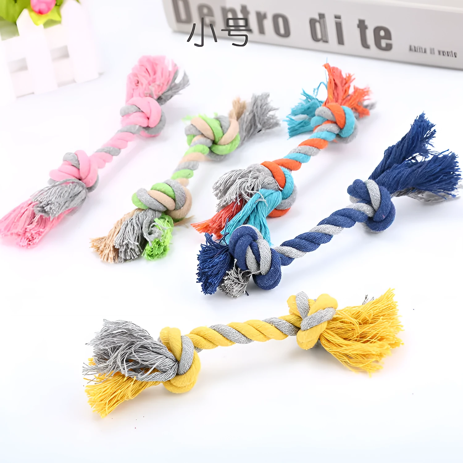 Cotton rope dog toy in medium size with braided texture, available in green, light blue, navy blue, pink, and yellow