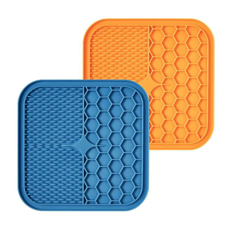 Blue silicone suction cup licking pad for dogs with grooved slow-feeding surface on a tile floor