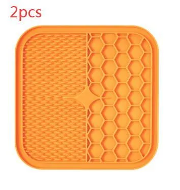 Blue silicone suction cup licking pad for dogs with grooved slow-feeding surface on a tile floor
