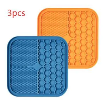 Blue silicone suction cup licking pad for dogs with grooved slow-feeding surface on a tile floor