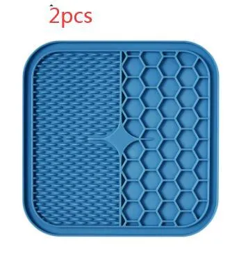 Blue silicone suction cup licking pad for dogs with grooved slow-feeding surface on a tile floor