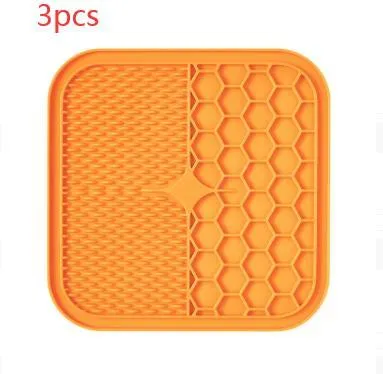 Blue silicone suction cup licking pad for dogs with grooved slow-feeding surface on a tile floor
