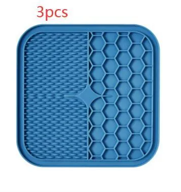Blue silicone suction cup licking pad for dogs with grooved slow-feeding surface on a tile floor