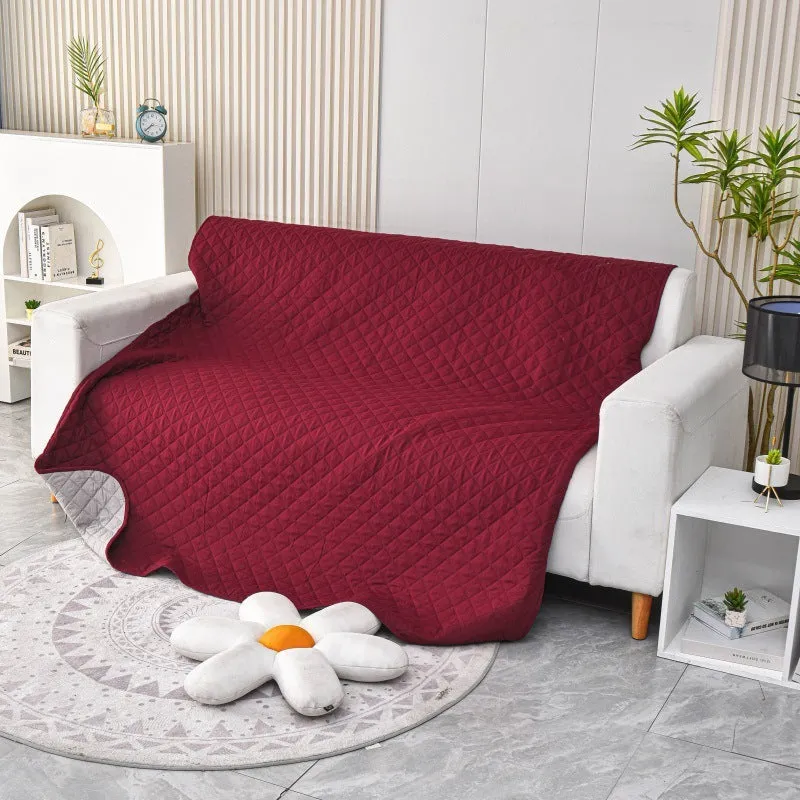 Reversible waterproof dog blanket sofa cover in grey, laid flat on a sofa