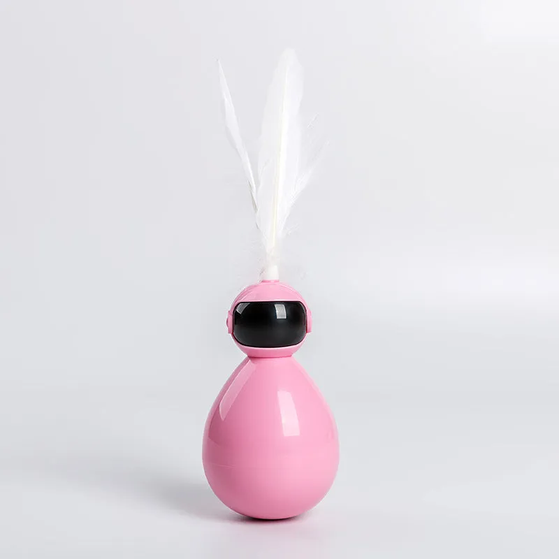 Tumbler cat toy in white with three replacement feathers on a light background