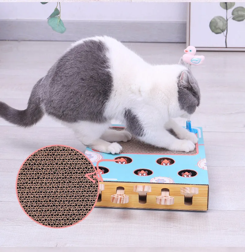 Blue cat toy teaser whack-a-mole game on floor, 36x26x6cm, cardboard and wood construction.
