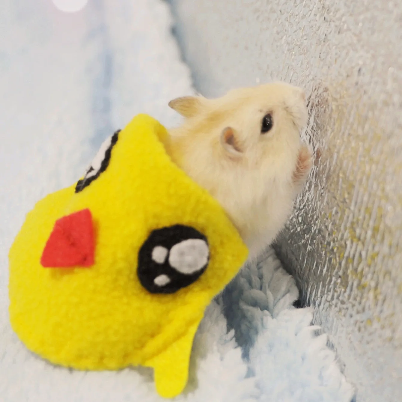Pet hamster wearing a bunny costume in a cute style, showing the thin fabric design