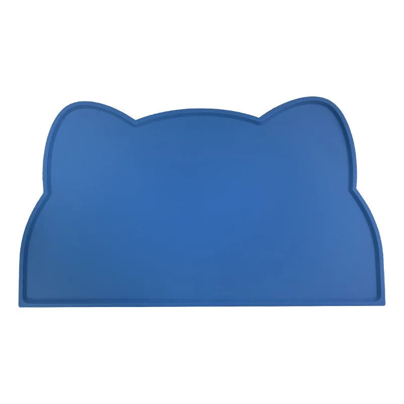 Blue cat head shaped silicone pet feeding mat placed under food and water bowls.