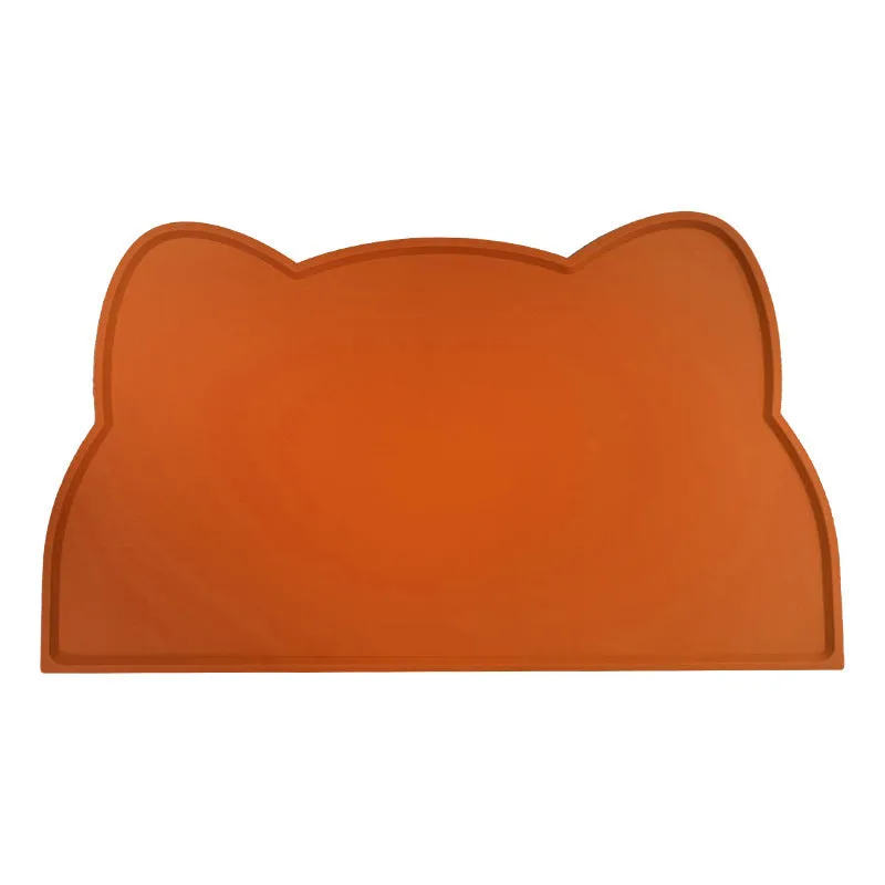 Blue cat head shaped silicone pet feeding mat placed under food and water bowls.