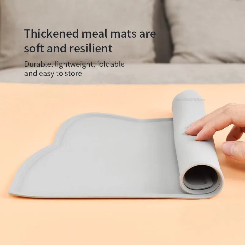 Blue cat head shaped silicone pet feeding mat placed under food and water bowls.