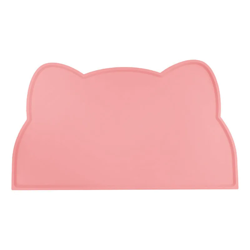 Blue cat head shaped silicone pet feeding mat placed under food and water bowls.