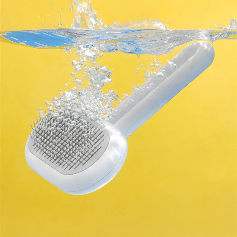Grey capsule cat dog grooming comb with stainless steel needles on surface
