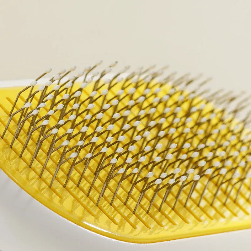 Grey capsule cat dog grooming comb with stainless steel needles on surface
