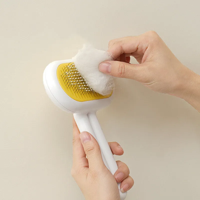 Grey capsule cat dog grooming comb with stainless steel needles on surface