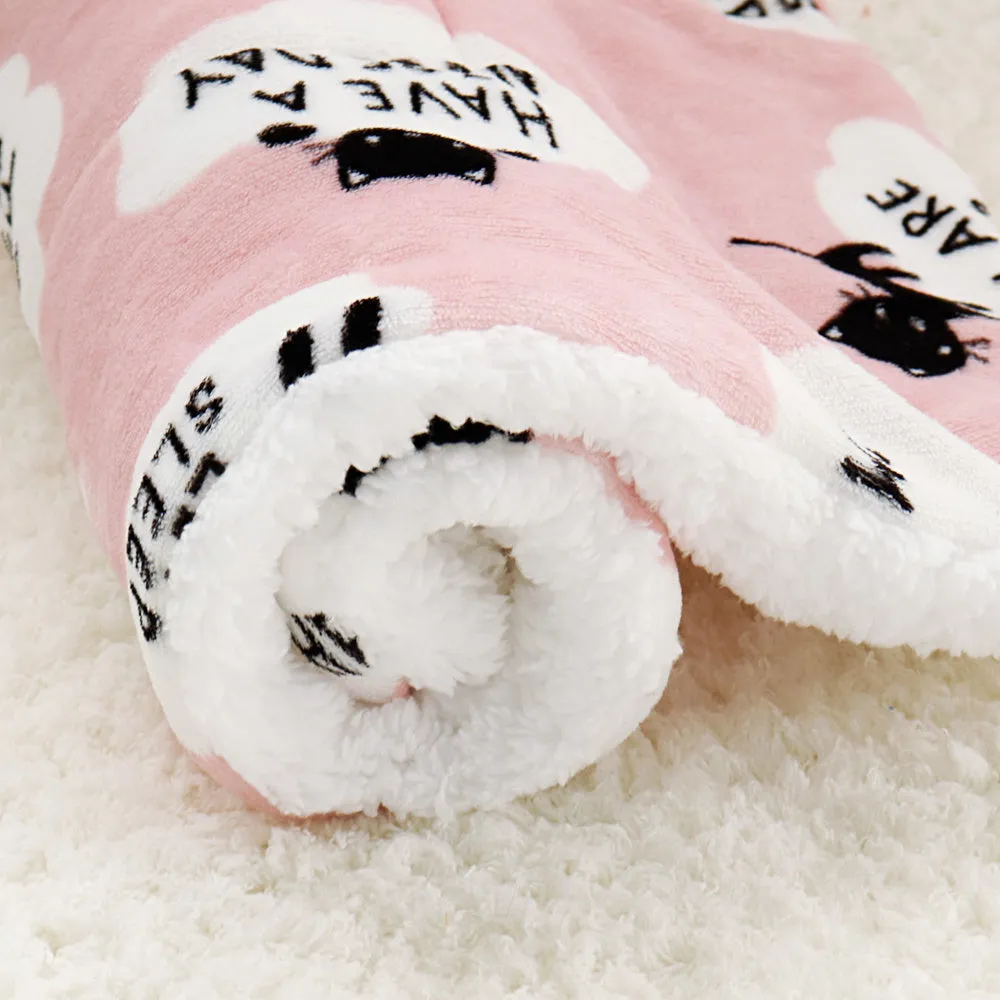 Lambskin pet blanket in flannel cashmere with cute cartoon pattern, grey colour, 55x70cm size on a pet bed