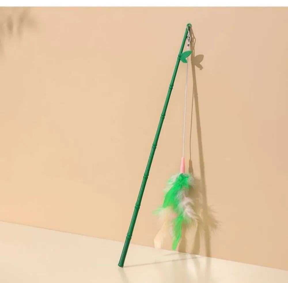Green interactive cat wand toy with feather and bell attachments for stimulating play