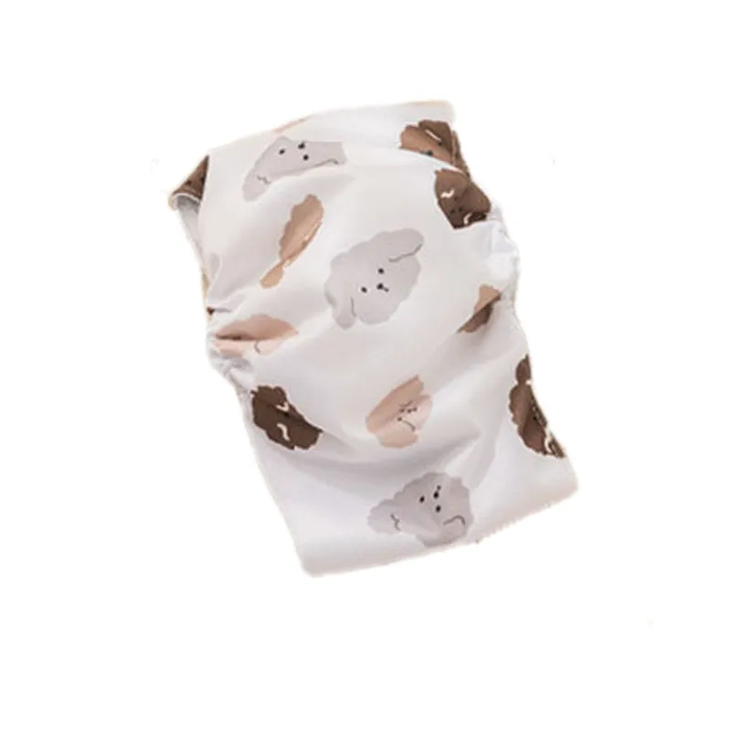 Reusable male dog diaper belly band with cartoon bone paw print design and fastener tape.