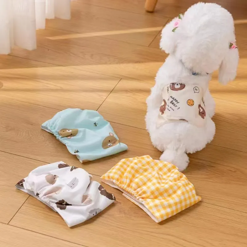 Reusable male dog diaper belly band with cartoon bone paw print design and fastener tape.
