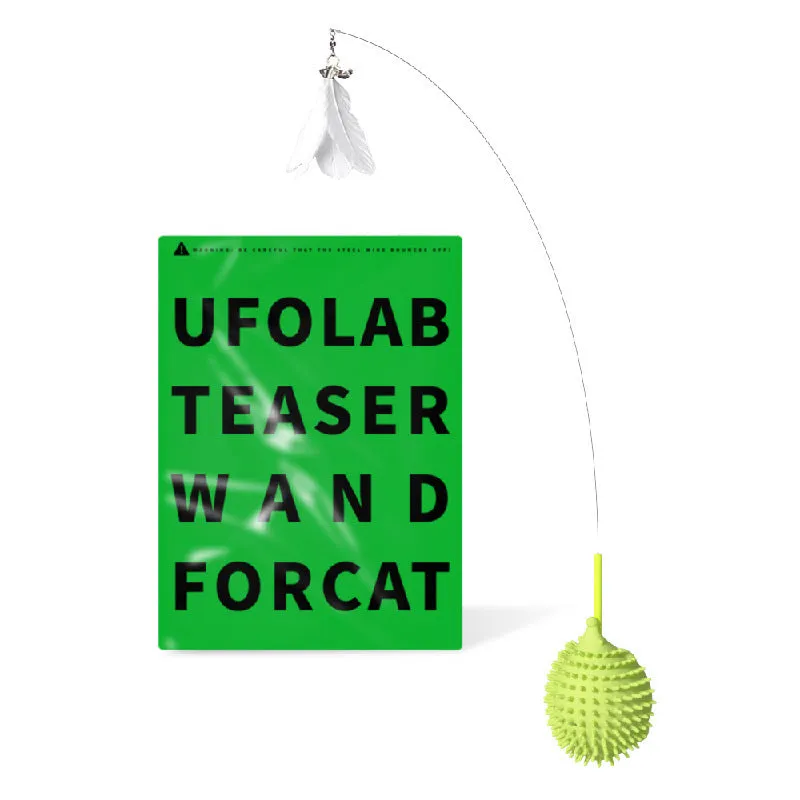 Green cat corner scratcher with plastic base and long teaser stick on a light background