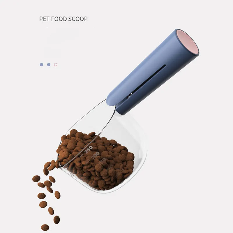 Transparent plastic pet food spoon with scale markings for measuring cat and dog dry food, available in Blue Pink White