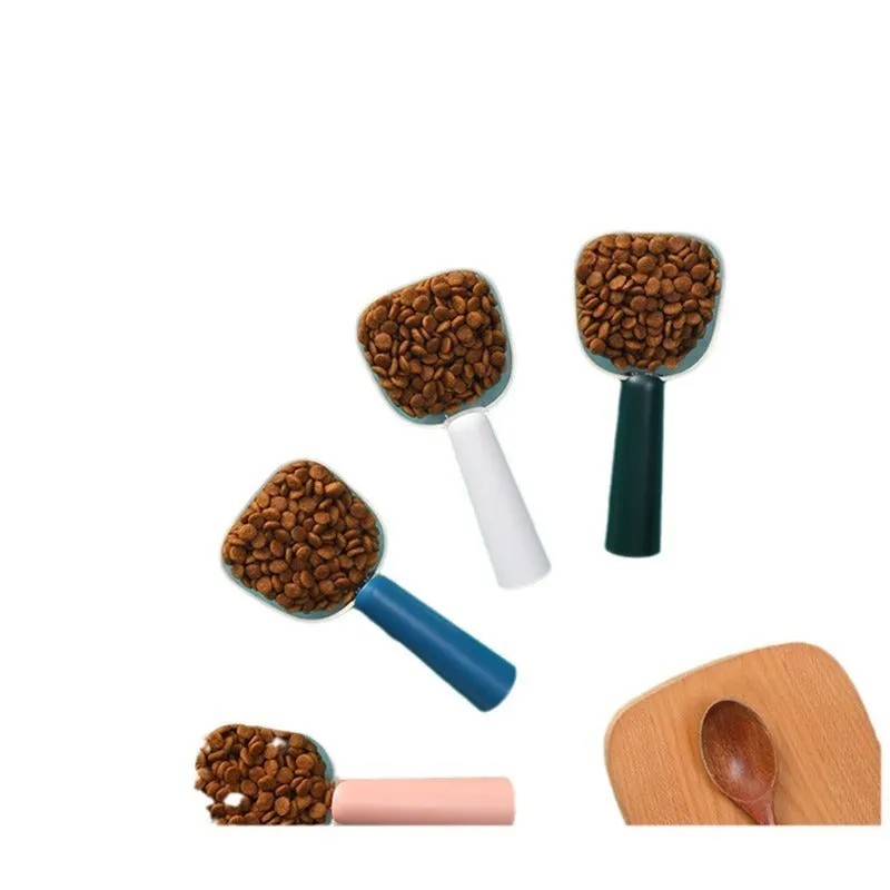 Transparent plastic pet food spoon with scale markings for measuring cat and dog dry food, available in Blue Pink White