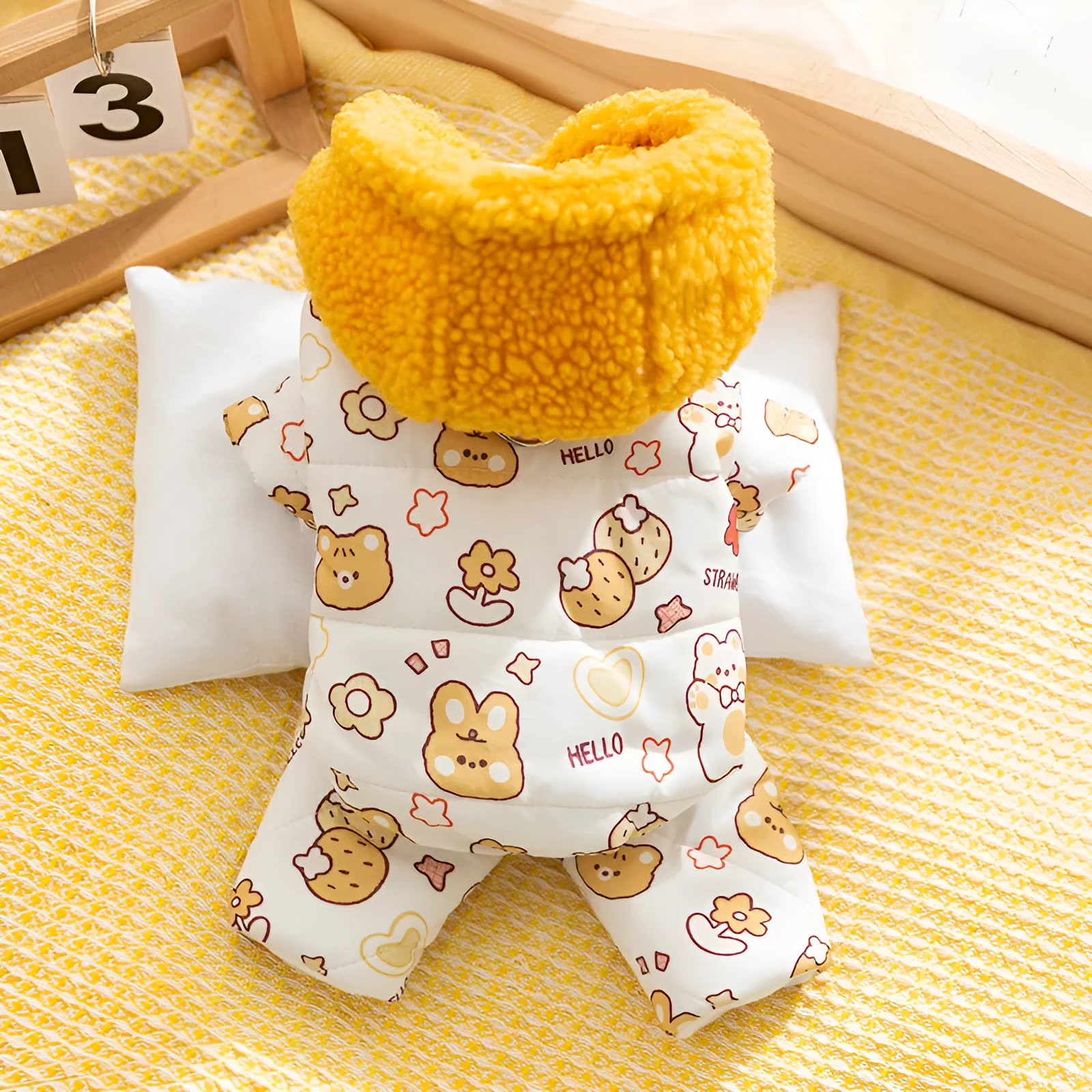 Yellow quilted cotton four-legged dog coat with sherpa hood and animal prints on a small dog