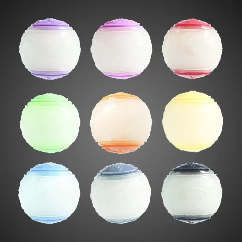 TPR dog training ball with squeaker in bright two-tone colours, showing molar texture on surface.