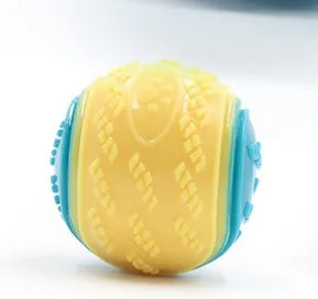 TPR dog training ball with squeaker in bright two-tone colours, showing molar texture on surface.