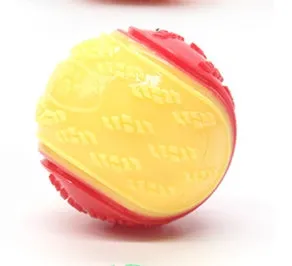 TPR dog training ball with squeaker in bright two-tone colours, showing molar texture on surface.