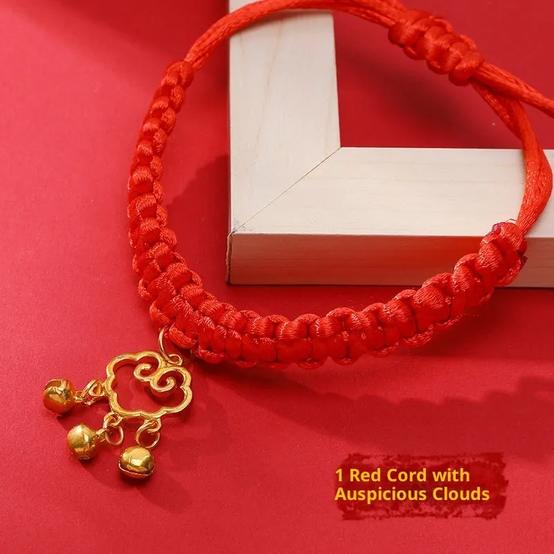 Adjustable hand-woven red rope pet collar with alloy lucky charm on wooden surface