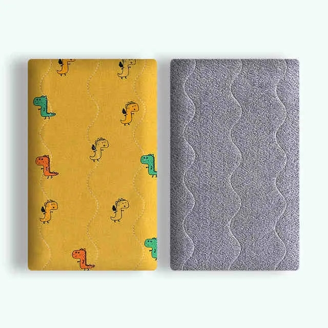 Colourful double-sided cotton pet blanket with dinosaur print, shown next to a dog bed.