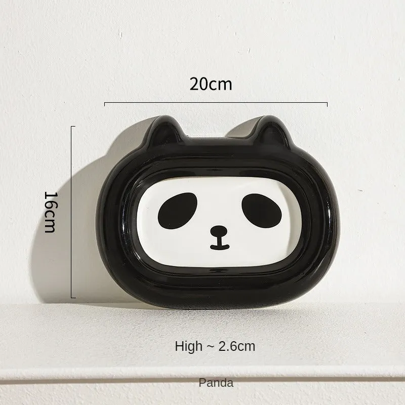 Glazed ceramic pet food bowl with animal design and non-slip rubber base ring.