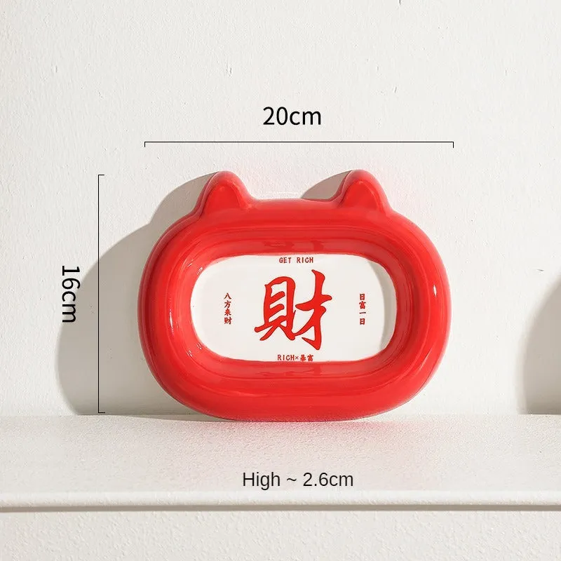 Glazed ceramic pet food bowl with animal design and non-slip rubber base ring.
