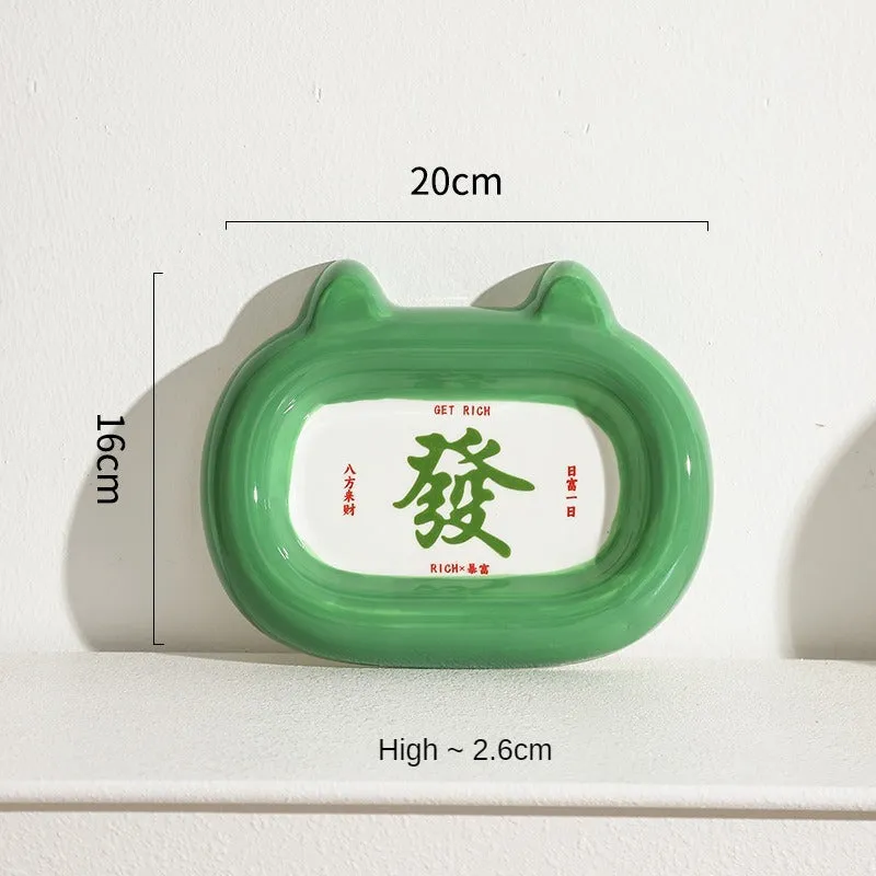 Glazed ceramic pet food bowl with animal design and non-slip rubber base ring.