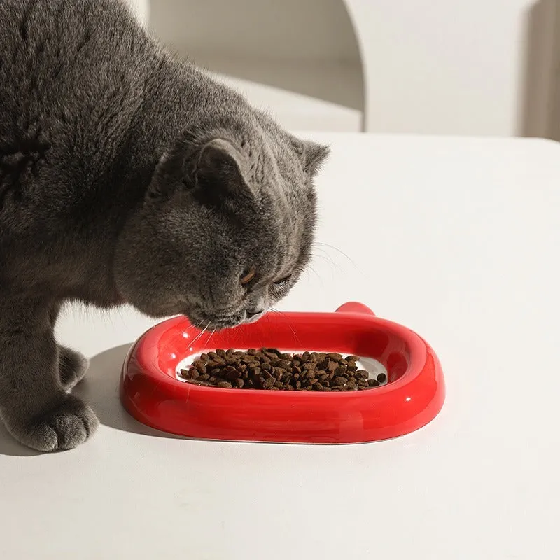 Glazed ceramic pet food bowl with animal design and non-slip rubber base ring.