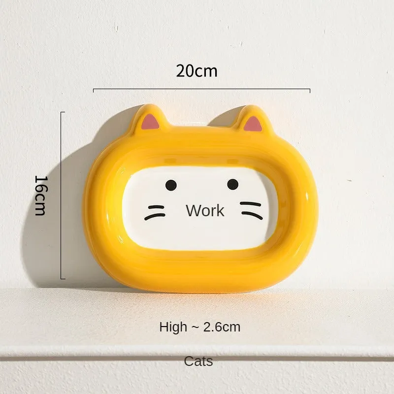 Glazed ceramic pet food bowl with animal design and non-slip rubber base ring.