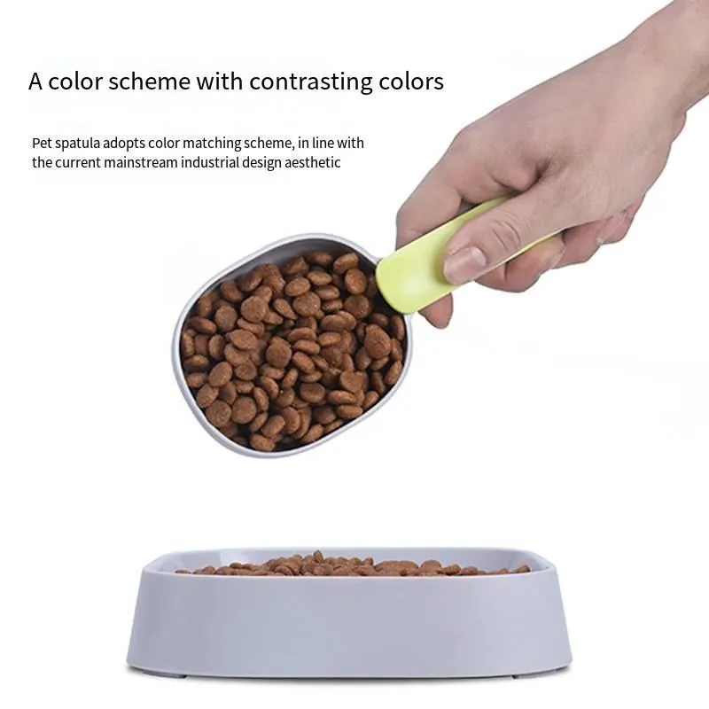 Blue plastic pet food scoop with ergonomic handle and bag clip on a white background