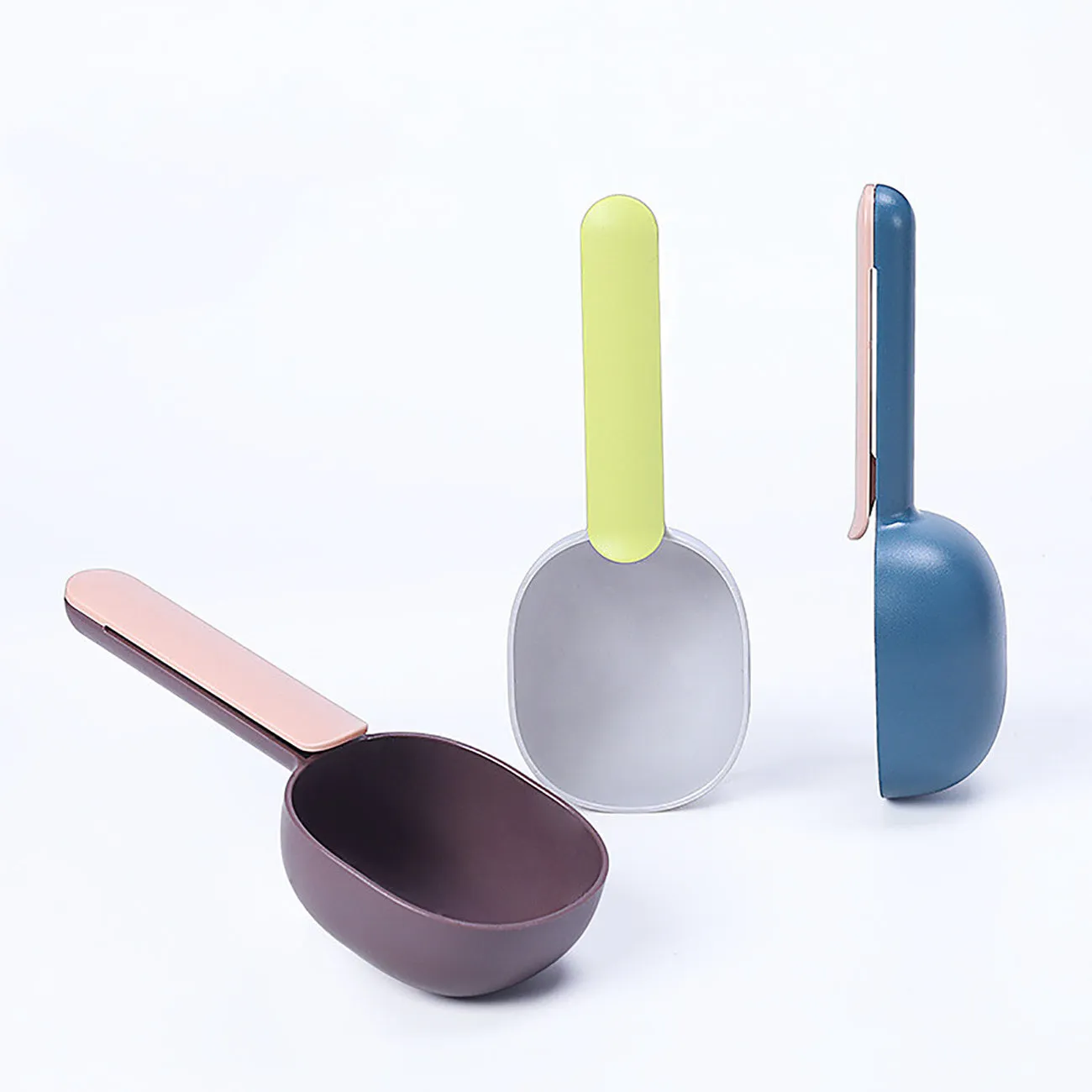 Blue plastic pet food scoop with ergonomic handle and bag clip on a white background